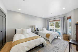 Bedroom with access to exterior, recessed lighting, and a closet