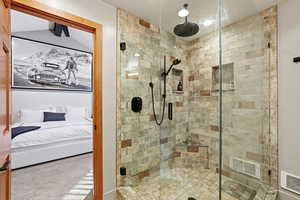 Bathroom featuring ensuite bath, a shower stall, and carpet flooring