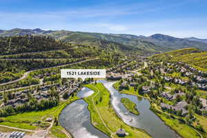 Aerial perspective of suburban area with a water and mountain view