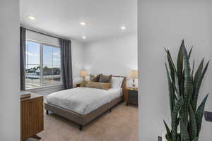 Carpeted bedroom with recessed lighting