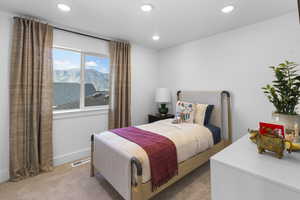 Bedroom featuring light carpet, a mountain view, and recessed lighting