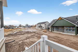 View of yard with a residential view and a balcony