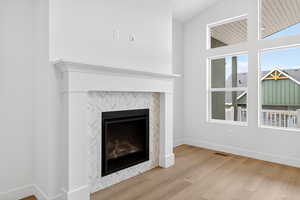 Detailed view of a tile fireplace and wood finished floors