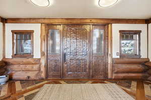 Foyer featuring rustic walls