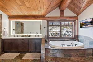 Full bath featuring wooden ceiling, double vanity, a garden tub, and an enclosed shower