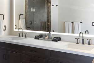 Full bathroom with a shower stall and double vanity