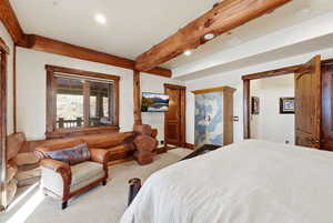 Carpeted bedroom featuring recessed lighting and beam ceiling