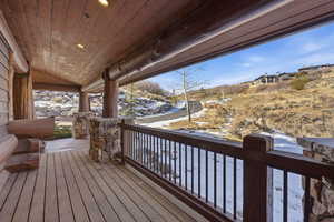 Snow covered deck with a porch