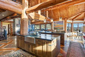 Kitchen featuring pendant lighting, inlaid floor details, a center island with sink, open floor plan, and a mountain view