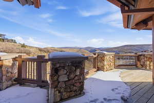 View of patio with a deck with mountain view