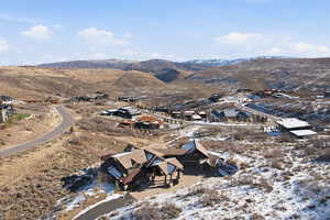 Aerial overview of property's location featuring a mountainous background and nearby suburban area