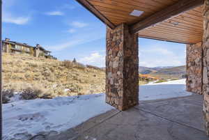 Snow covered patio featuring a mountain view