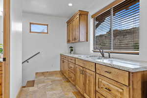2nd Floor – Bedroom #4 with Wet Bar. Laundry room featuring light stone finish flooring and recessed lighting
