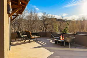 Upper Deck – Mountain & River Views. View of patio / terrace featuring a fire pit