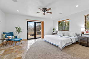 2nd Floor – Bedroom #4 with Sliding Glass Door to Deck. Bedroom with stone tile flooring, access to outside, multiple windows, ceiling fan, and recessed lighting