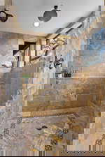 Primary Suite – Walk-In Shower. Full bathroom with a tile shower