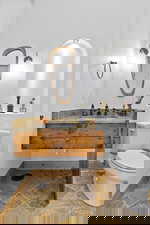 Half Bathroom on Main Floor. Bathroom with stone tile floors and vanity