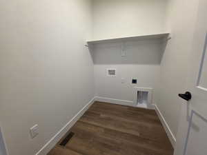 Laundry room featuring dark wood-type flooring, hookup for a washing machine, and electric dryer hookup