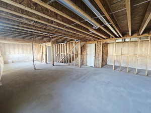 Unfinished below grade area featuring stairway