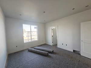 Unfurnished bedroom featuring baseboards and carpet flooring