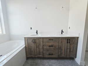 Full bathroom with double vanity and a garden tub