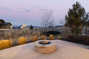 View of patio with a fire pit and a mountain view