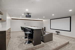 Cinema featuring light carpet and recessed lighting