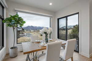 Dining area with a mountain view and light wood-type flooring