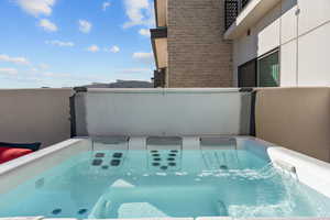 Hot tub just outside the primary bedroom and next to pool