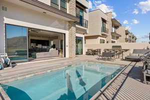 Private pool located off the main level family room/kitchen area with BBQ/dining area