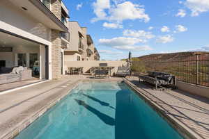 Private pool located off the main level family room/kitchen area with BBQ/dining area