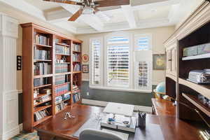 Home office featuring a ceiling fan, coffered ceiling, crown molding, and beamed ceiling