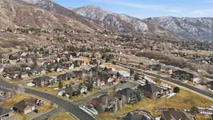 Aerial view of property's location featuring nearby suburban area and a mountain backdrop