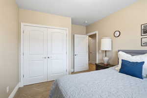 Bedroom featuring a closet and light carpet