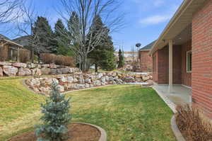 View of green lawn featuring a patio area