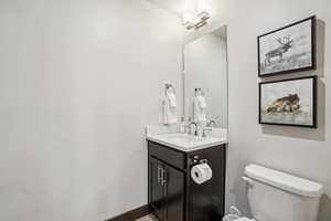 Half bath featuring vanity and toilet