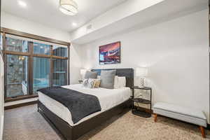 Carpeted bedroom with access to outside