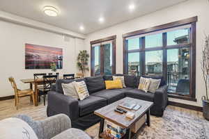 Living area featuring light wood-style floors and recessed lighting