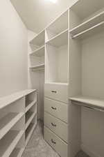 Spacious closet with light colored carpet