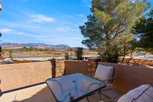 Patio / terrace featuring outdoor dining area and a mountain view