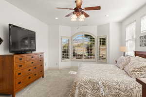Bedroom featuring light carpet, a ceiling fan, and recessed lighting