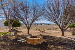 View of yard with a fire pit, a rural view, and a mountain view