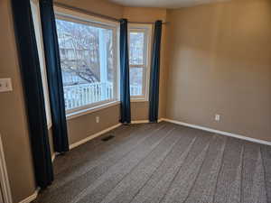 Unfurnished room featuring carpet flooring and baseboards