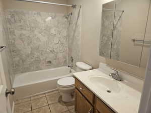 Full bathroom with vanity, shower / bath combination, and light tile patterned floors