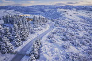 Snowy aerial view featuring a mountain view