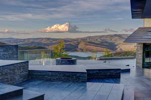 View of patio featuring a mountain view and an outdoor fire pit