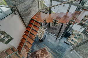 Stairway featuring a towering ceiling