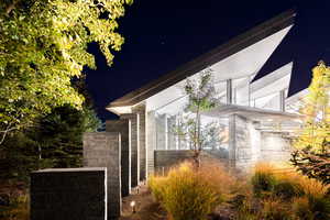 Property exterior at twilight with stone siding
