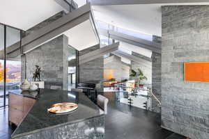 Dining room featuring a high ceiling and healthy amount of natural light