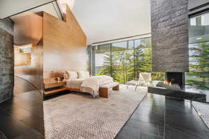 Bedroom with a towering ceiling and a fireplace